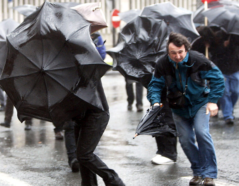 People Fight Against Strong Winds And Rain