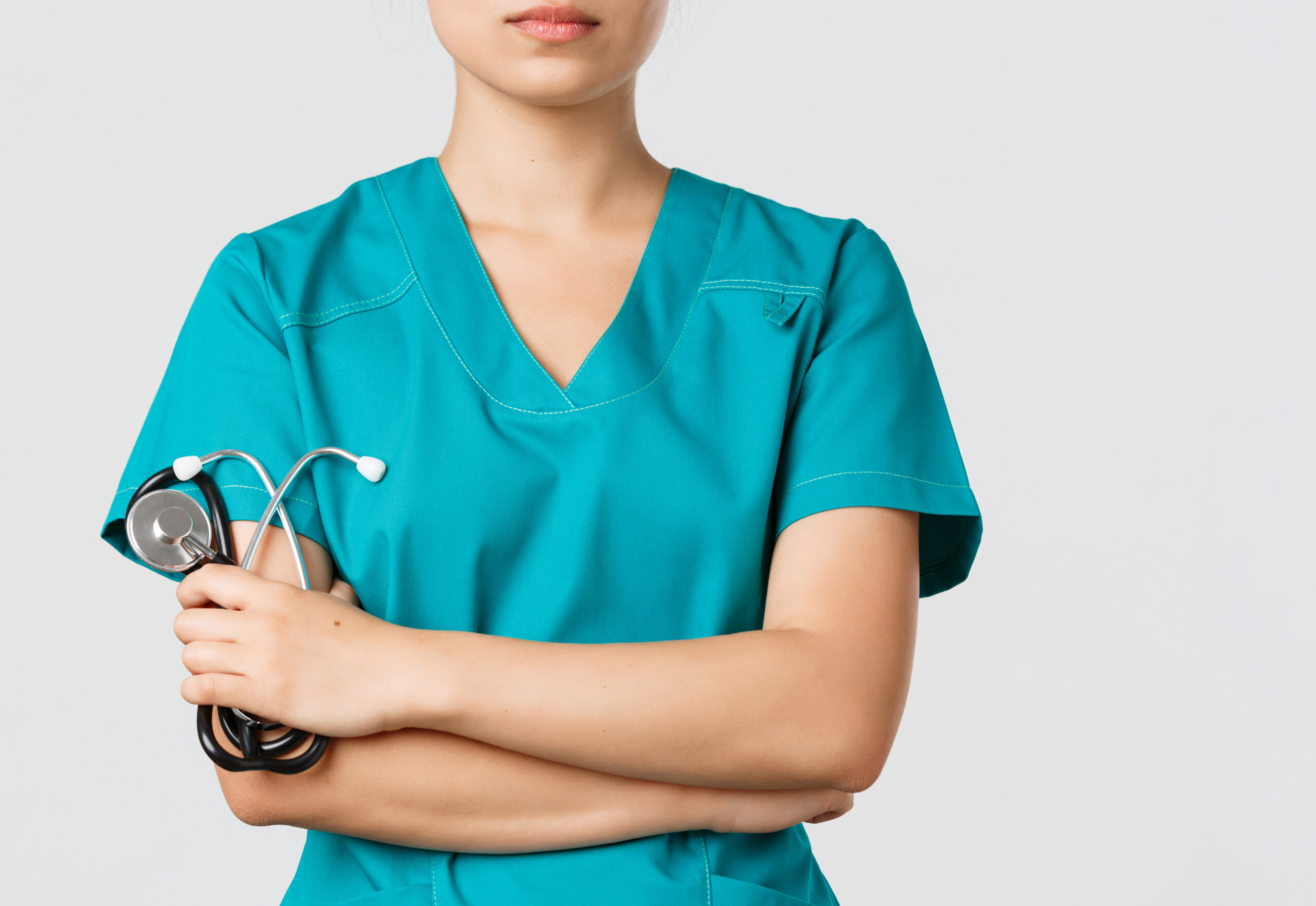 Covid 19, Coronavirus Disease, Healthcare Workers Concept. Close Up Of Confident Female Asian Physician, Doctor In Medical Scrubs, Cross Arms Determined And Holding Stethoscope, White Background