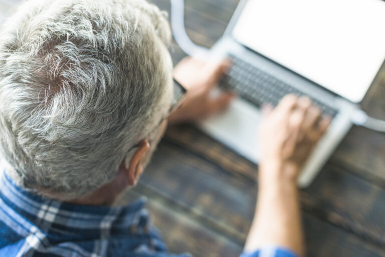 Overhead View Senior Man Using Laptop